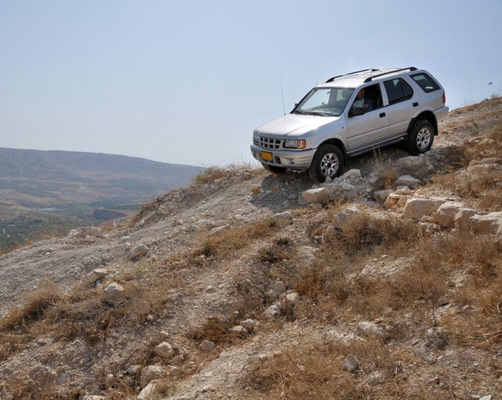 Silver SUV off-roading in mountainous, dry climate